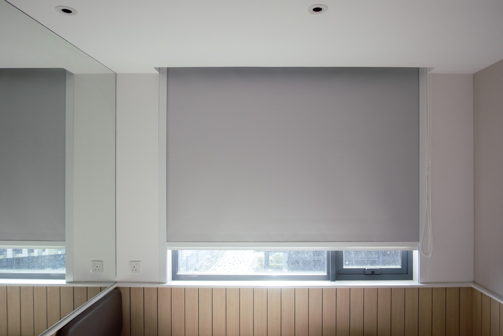 Blackout roller shades with side tracks.